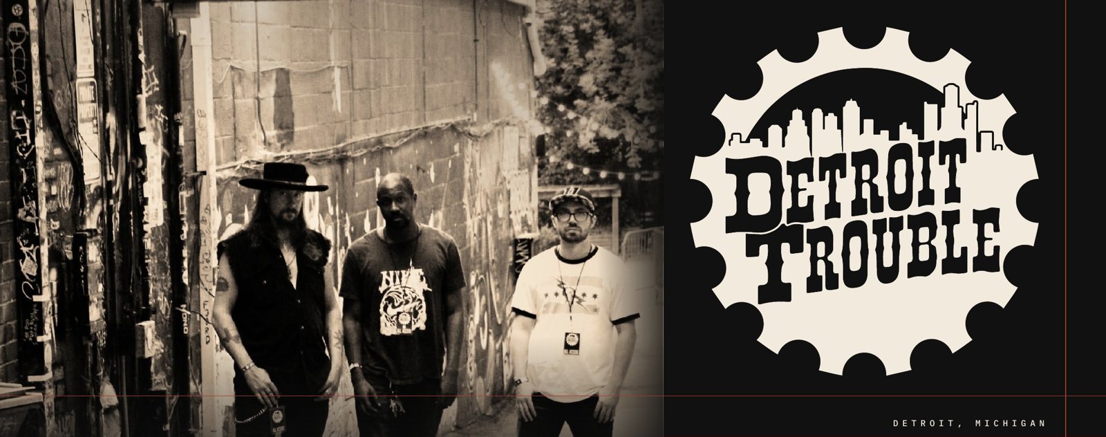 The opening of the final Detroit Trouble EPK: the three band members standing without instruments in a Detroit alley, beside the oversized Detroit Trouble gear logo.