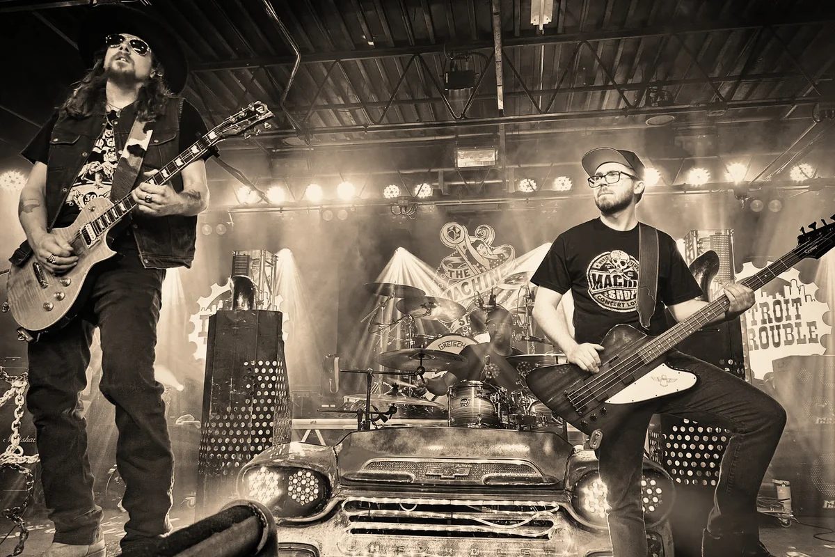 Detroit Trouble performing live on a stage built around a vintage truck front end.
