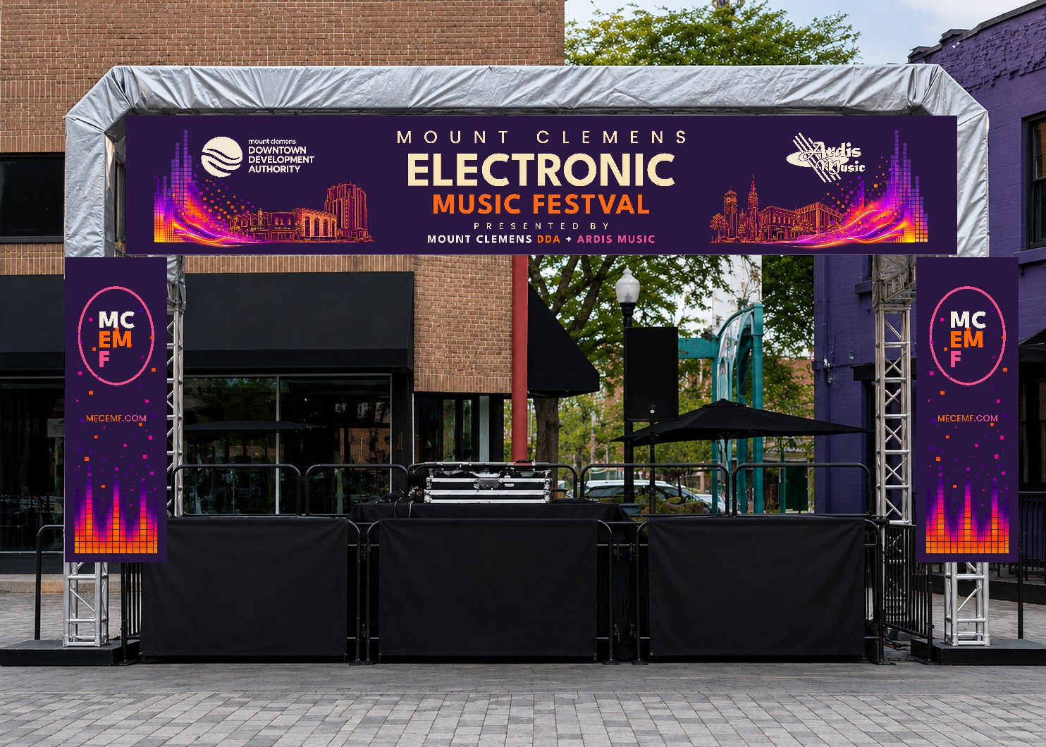 MCEMF stage banner installed downtown with sponsor identification.