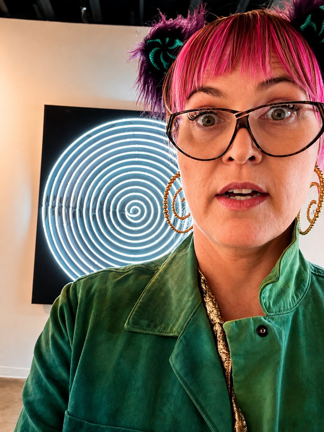 Jody Tyree at Spot Lite in Detroit, in front of a neon spiral art installation
