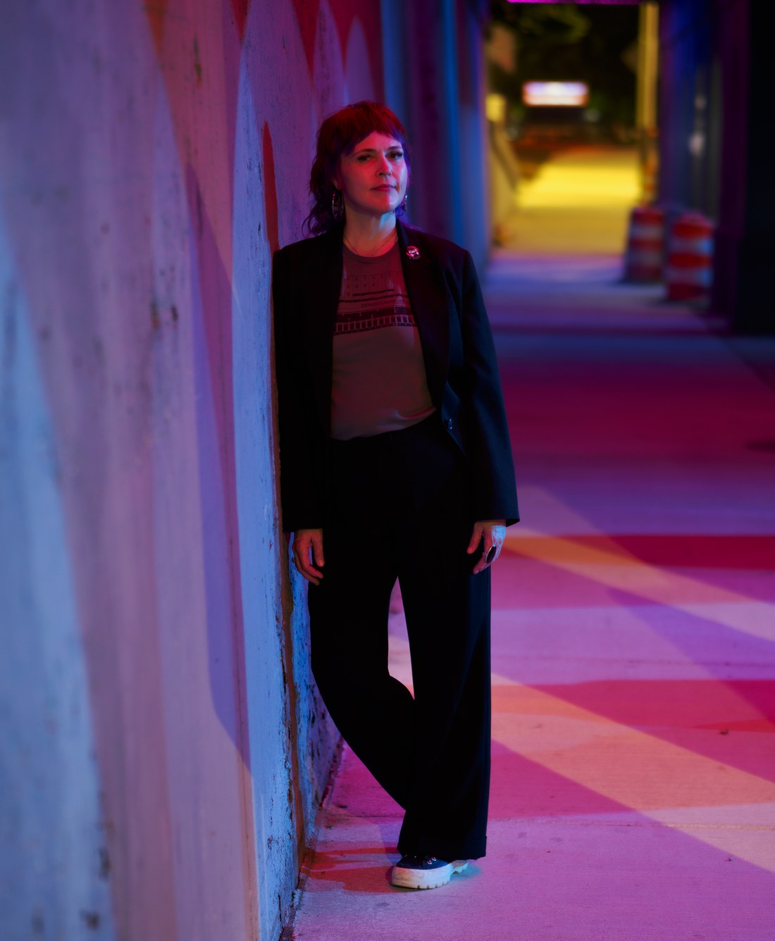 Jody Tyree photographed in a pink and blue illuminated Detroit passageway.