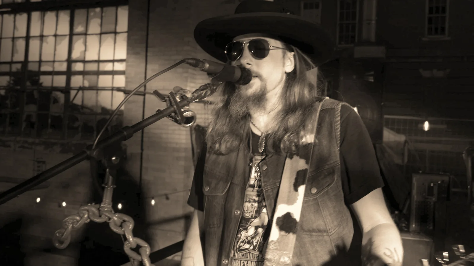 Kidd Lightning singing at the microphone in the Here Tonight official video.